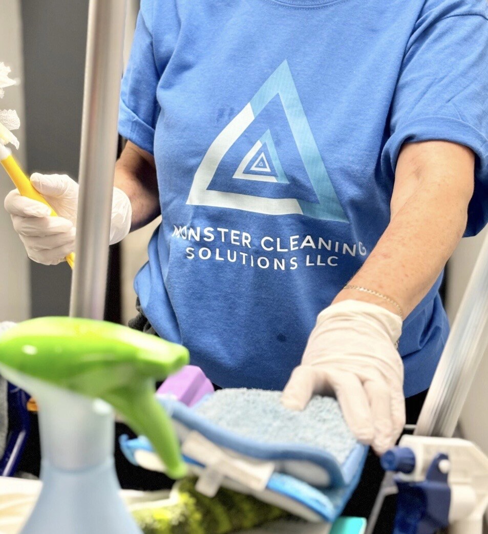 Monster Cleaning Solutions team member preparing professional cleaning supplies